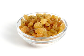 Yellow raisins in a glass bowl stand on a white background.	