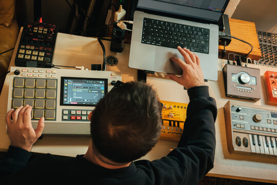 Beatmaker in a studio producing some music with an Akai MPC LIVE II