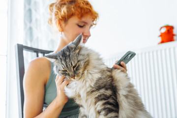 young woman spends time with her pet cat