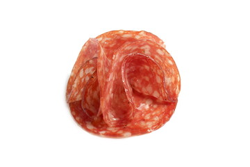 Round pieces of salami lie on a white background.	