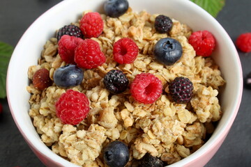 There is dry breakfast with berries on the plate.