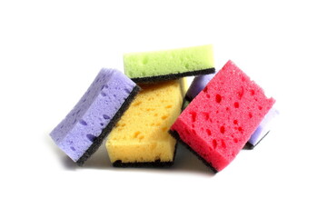Many soft sponges for washing dishes lie on a white background.