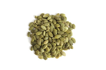 On a white background lies a small piece of peeled green pumpkin seeds.