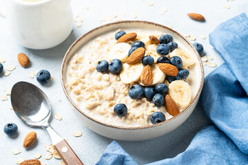 Oatmeal porridge with bananas, nuts and blueberries.
