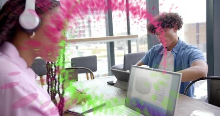 woman putting on headphones initiating green magenta particle swirl around business colleagues - Powered by Adobe