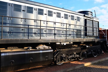 A vintage-style train engine sits idle on the tracks