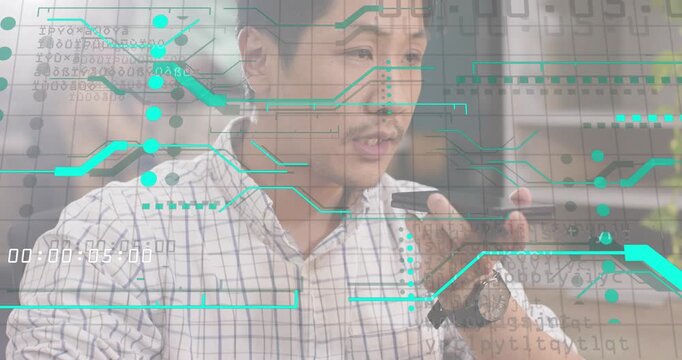 Man raising smartphone initiating voice command at desk for digital control with green UI animating