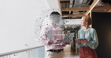 Man pointing laptop launching holographic tech globe showing data overlay while colleague nodding - Powered by Adobe