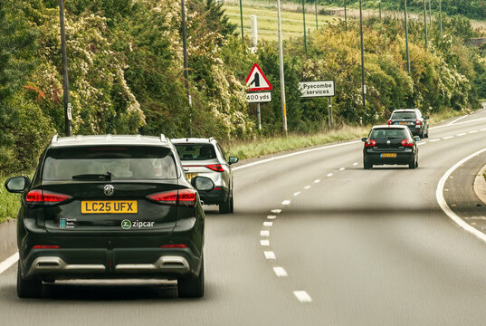 Zipcar on A road, England cars on motorway in England. UK, Car for rent. Sharing Zipcar business.