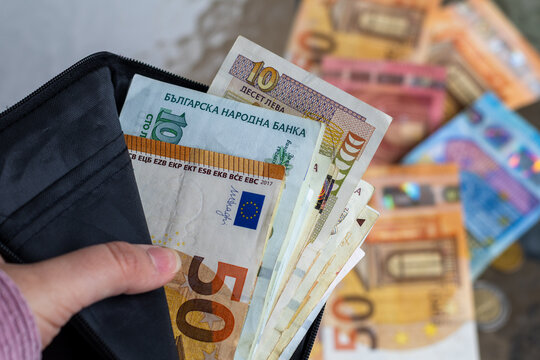 Bulgarian Lev and Euro banknotes in a wallet, symbolizing Bulgaria's financial shift towards Euro adoption.