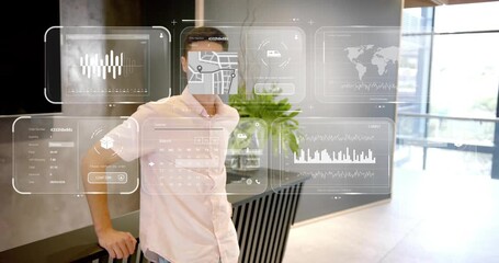 Male presenter leaning on table in reception, demonstrating tech data panels appearing around him - Powered by Adobe