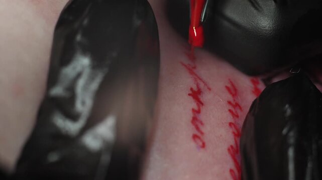 Tattoo machine close up is making paint. Red ink color needle. Extreme macro slow motion