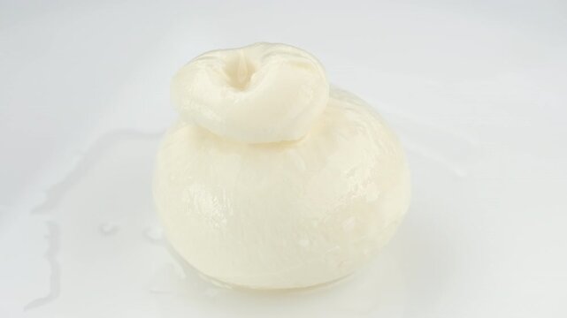 Italian burrata cheese isolated on white background, rotation