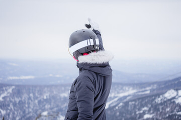 A girl at a ski resort raised her hand up