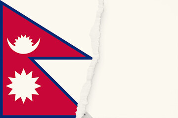The flag of Nepal is halved by a ripped white portion, illustrating fragility and incomplete representation, with a distinctive triangular design and symbolic crescent moon and star