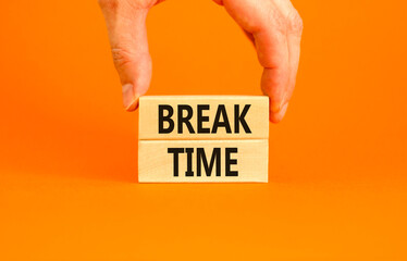 Break time symbol. Concept word Break time on beautiful wooden blocks. Beautiful orange paper background. Businessman's hand. Business break time concept. Copy space.