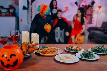 Joyful office Halloween party with coworkers in costumes, celebrating with drinks and laughter, fostering teamwork and festive spirit