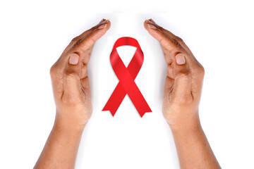 Aids awareness ribbon with hands on white background.