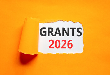 Grants 2026 symbol. Concept words Grants 2026 on beautiful white paper. Beautiful orange paper background. Business and grants 2026 concept. Copy space.