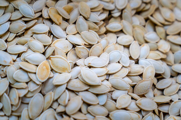Roasted, shelled pumpkin seeds. Top view photo.