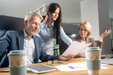Multiethnic business people working together in the office. Corporate business team and manager in a meeting. Image of three business people working at meeting	