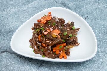 Gourmet Beef Stir Fry with Rich Brown Sauce, Mushrooms, and Star Cut Carrots in plate side view of japanese food