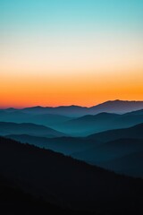 Fototapeta premium Silhouetted mountain ranges layered against a vibrant gradient sunset sky mountains landscape