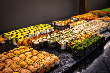 Delicious photo of sushi rolls served on a plate, including fresh fish, rice, and seaweed. Beautiful presentation with vibrant colors, perfect for food, culinary, and restaurant themes.
