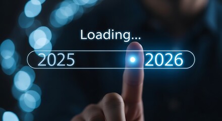 Finger pressing loading bar from 2025 to 2026 with bokeh lights