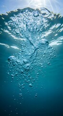 Bubbles rising in blue water towards a sunlit surface, ideal for spa ads, nature concepts, underwater themes, and relaxation designs.