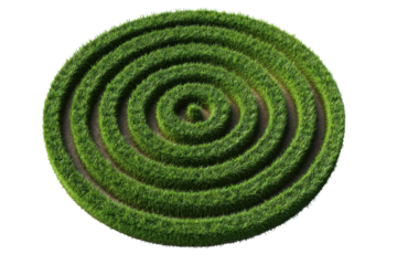 Green spiral maze design showcases fresh grass in a circular pattern set on a bright background during daylight hours