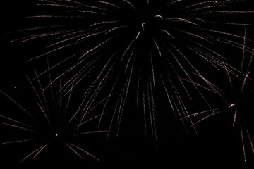 Fireworks on the dark sky background. Colorful fireworks. Abstract colored firework background with free space for text. fireworks light up the night sky. New year celebration fireworks 