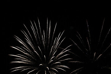 Fireworks on the dark sky background. Colorful fireworks. Abstract colored firework background with free space for text. fireworks light up the night sky. New year celebration fireworks 