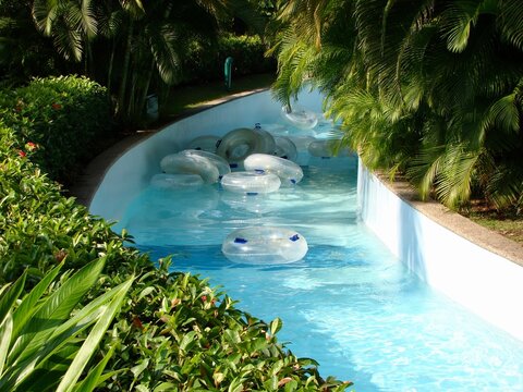 lazy river pool in tropical resort with empty tubes