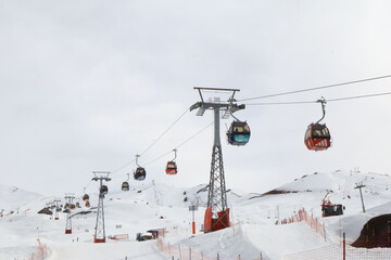 Cable Cars Ascending Snow-Covered Slopes at Alpine Ski Resort