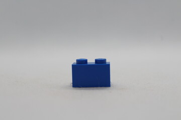 Naklejka premium Blue Lego brick piece isolated on a white background 