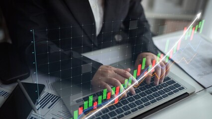 Business professional engaged in financial analysis using a laptop, with a digital graph overlay depicting growth trends and investment strategies for effective decision-making. Copula