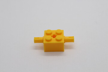 Obraz premium Yellow Lego brick piece isolated on a white background 