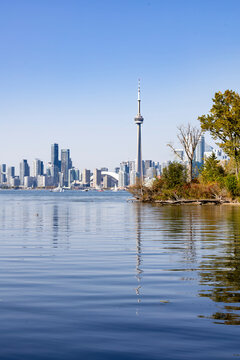 Stunning view of Toronto's skyline from Ward's Island at Sunfish Cut, featuring iconic landmarks like the CN Tower against a serene waterfront backdrop.
