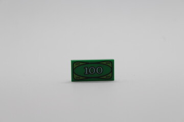 Naklejka premium Lego money piece isolated on a white background 