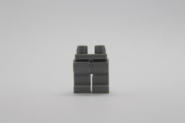 Naklejka premium Grey Lego figure legs isolated on a white background 