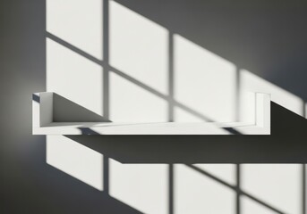 Sunlight casting geometric shadows on a minimalist shelf