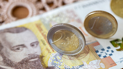 Eurozone Bulgaria, Financial and economic concept. Euro coins and a 50 Bulgarian lev note lying on a tablecloth.