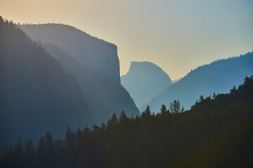 Half Dome at Sunrise with Misty Mountain Ridges and Pine Forest Yosemite National Park
