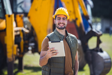 Excavator operator with tablet at construction site