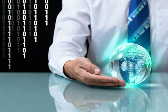 Businessman holding a glowing digital globe representing global technology and data. - Powered by Adobe