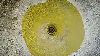 spiral hand-drawn brush stroke on a distressed wall, with yellow halftone gradients peeling like old posters. The spiral slowly rotates while textures of scratched concrete and torn paper flicker