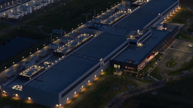 Futuristic Meta data center illuminated against evening sky.