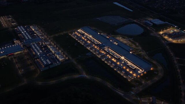 Illuminated AI infrastructure hub and cloud data facility at night.