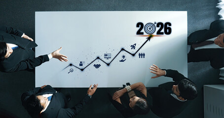 A collaborative scene depicting business professionals strategizing with a growth graph and projections leading into 2026, emphasizing teamwork and future planning. Trope